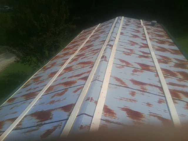 Rusted metal roof panels with new wood purlins before replacement — Storm Damage Roof Repair in Rochdale by Roofing Brothers